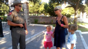 Holding her children's hands, Hillary Procknow confronts State Trooper.