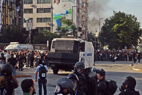 Hundreds of police officers, along with water cannon trucks, sitting in Taksim Square.