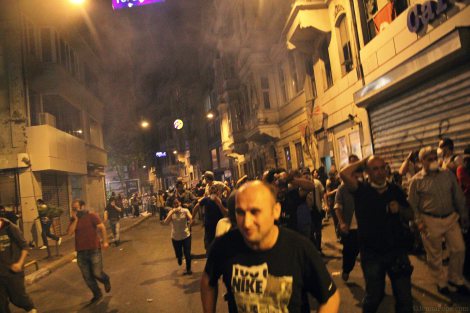 Tear gas hanging in the air above protestors as they are pushed further from Taksim Square.