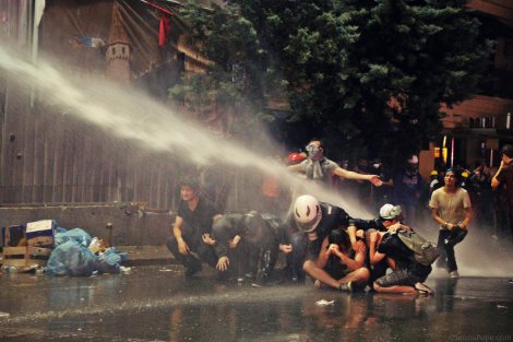 Protestors being sprayed with a water cannon.